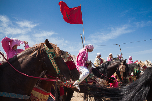 The riders of Farisat Al Hawzia wait with their Arab-Barb horses at the starting line of a Tbourida performance.