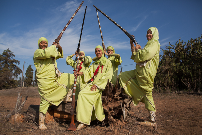 Members of Farisat Al Hawzia share a playful moment together before a Tbourida training session.